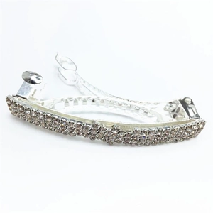 Close-up of triple-row rhinestone spring hair clip with sparkling silver metal base
