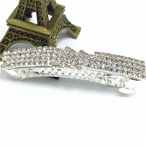 Detailed view of silver alloy hair clip with rows of sparkling transparent rhinestones
