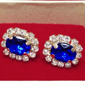 Classic vintage gold stud earrings with oval blue crystal and shimmering halo rhinestones
