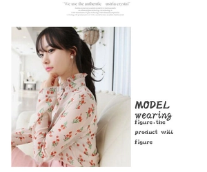 Detailed close-up of a floral chiffon shirt with ruffled high neck and red tulip patterns