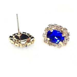 Elegant gold flower stud earrings with deep blue oval sapphire and crystal accents