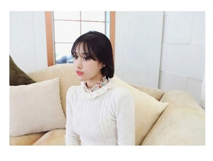 Elegant floral white flower pearl earrings styled with a white cable knit sweater