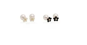 Detail view of ivory and black floral stud earrings with elegant pearl backings