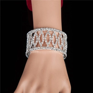 Macro detail of wide hollow bangle with pavé-set rhinestones on a wrist