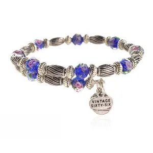 Detail of beaded bracelet featuring vintage navy and purple floral beads with silver spacers