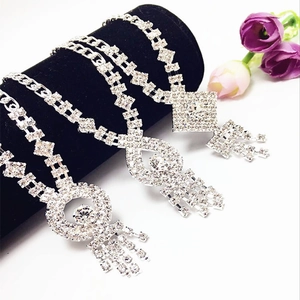 Elegant silver rhinestone fringe necklace with geometric crystal pendants on black velvet