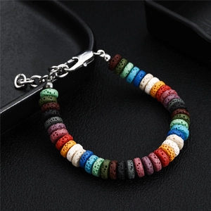 Close-up of colorful volcanic stone beads with porous texture and silver metal clasp