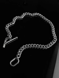 Detail of silver Cuban link necklace with T-bar closure and micro-set diamonds