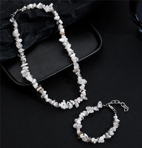 Detail view of irregular white natural stone necklace and bracelet set with silver clasps
