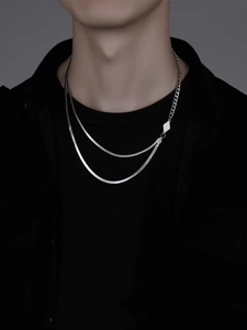 Detail of silver dual-layer chain with snake bone link and geometric diamond pendant