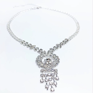 Detailed view of silver rhinestone tassel necklace with a sparkling round central pendant