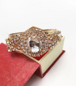 Detailed macro view of luxury gold wire bracelet with large oval stone and rhinestones
