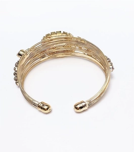 Detail of gold-plated multi-row wire cuff bracelet set with sparkling white rhinestones