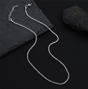 Detailed view of silver titanium steel chain with sparkling texture and lobster clasp