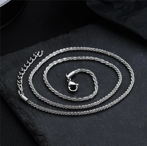 Macro shot of silver shimmering twist chain showing lobster clasp and extender detail
