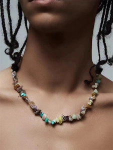 Detail of colorful irregular natural crushed stone beaded necklace on model neck