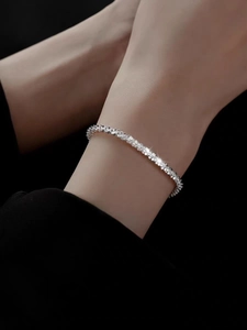 Close-up of shimmering silver titanium steel necklace worn on neck with sparkling detail