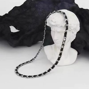 Detail of silver Cuban chain interwoven with black leather on David statue bust