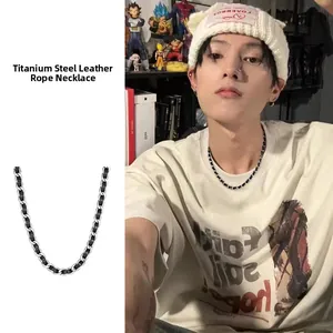 Titanium steel necklace with black leather chain detail shown on an Asian male model