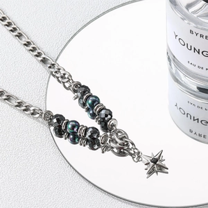 Chic titanium steel necklace featuring iridescent beads and a black obsidian star pendant