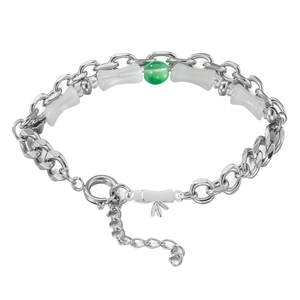Detail of silver chain bracelet featuring bamboo beads, green stone and bow charm