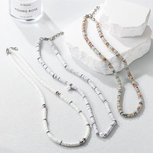 Three bohemian layered necklaces with colorful jasper beads and elegant pearl pendants