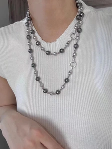 Gros plan du collier double rang en perles de Tahiti grises avec fermoirs en strass
