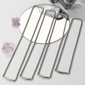 Detail view of silver stainless steel curb chain necklaces in four different lengths