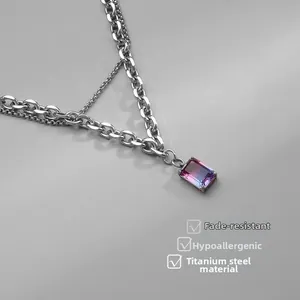 Detail of double-layer titanium necklace with gradient pink-to-purple gemstone pendant