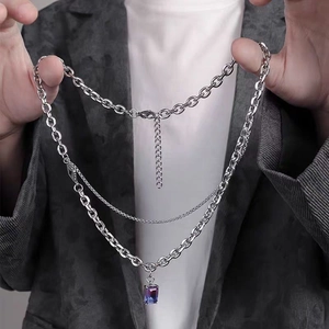 Detail of triple-layer titanium steel necklace featuring a gradient blue purple gemstone