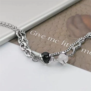 Detail shot of double-layer titanium steel bracelet with cat's eye stone and metal chains