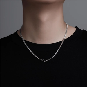 Close-up of flat silver snake chain necklace with unique hook clasp on model