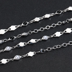 Detail of silver stainless steel chain bracelet with diamond shapes and black obsidian beads