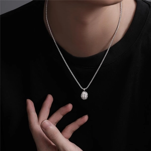 Minimalist silver geometric round pendant necklace with rippled texture shown on model