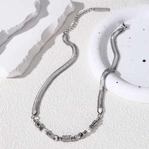 Titanium steel snake chain necklace with silver beads and white pearls on white stone