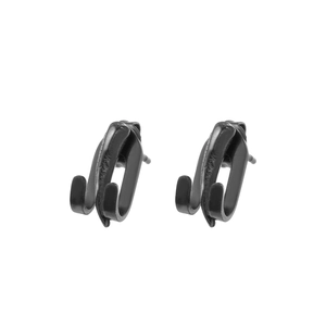 Macro shot of minimalist matte black double-claw stud earrings for men and women