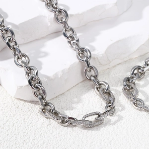 Detailed view of silver thick link chain with sparkling pavé cubic zirconia setting