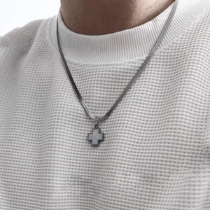 Detail of silver clover cross pendant with white shell on herringbone chain necklace