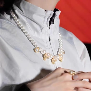 Hip hop pearl necklace and ring set with golden skull charms and sparkling diamonds