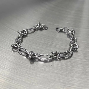 Detailed close-up of industrial style titanium steel chain bracelet with lobster clasp