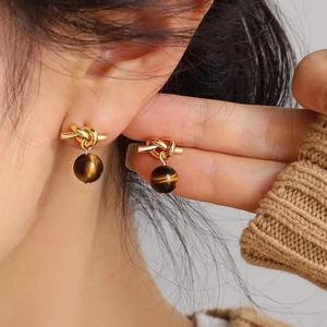 Maillard style gold knot stud earrings with tiger eye stone pendants for women