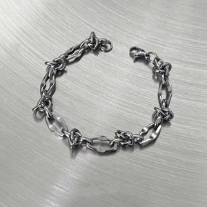 Detailed macro view of the silver irregular thorn chain links and lobster clasp structure