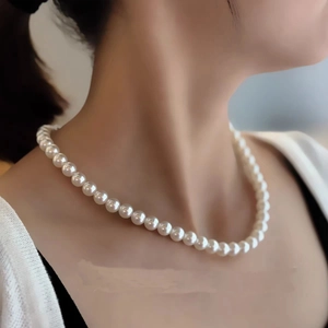 Elegant single layer round white pearl necklace for women with a minimalist aesthetic look