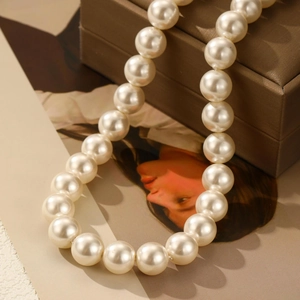 Close-up of elegant round pearl necklace displayed on a luxury silk jewelry box
