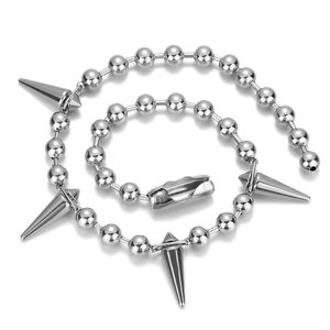 Punk style silver bead chain necklace with five conical metal spikes on white background