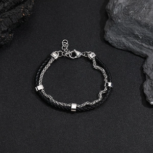 Detailed view of men's double-layer black leather cord and silver steel wheat chain bracelet