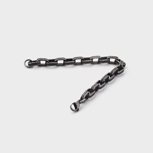 Close-up of vintage titanium steel chain bracelet with spiral texture and lobster clasp
