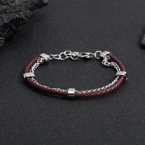 Detail view of burgundy braided leather bracelet with silver stainless steel links and clasp