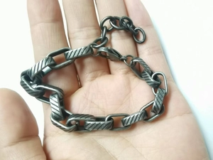 Detailed view of vintage silver titanium steel chain necklace with diagonal patterns