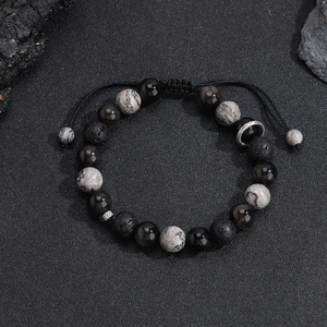 Close-up of snowflake obsidian and volcanic lava stone beads with braided cord